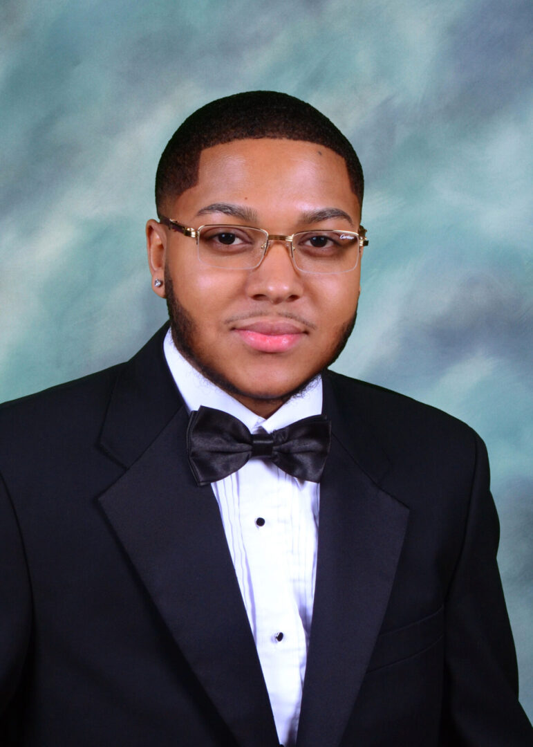 A Boy in Glasses in a Black Color Suit Jacket
