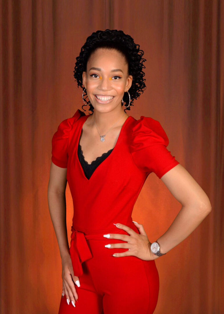 A Girl With Curly Hair in a Red Color Jump Suit