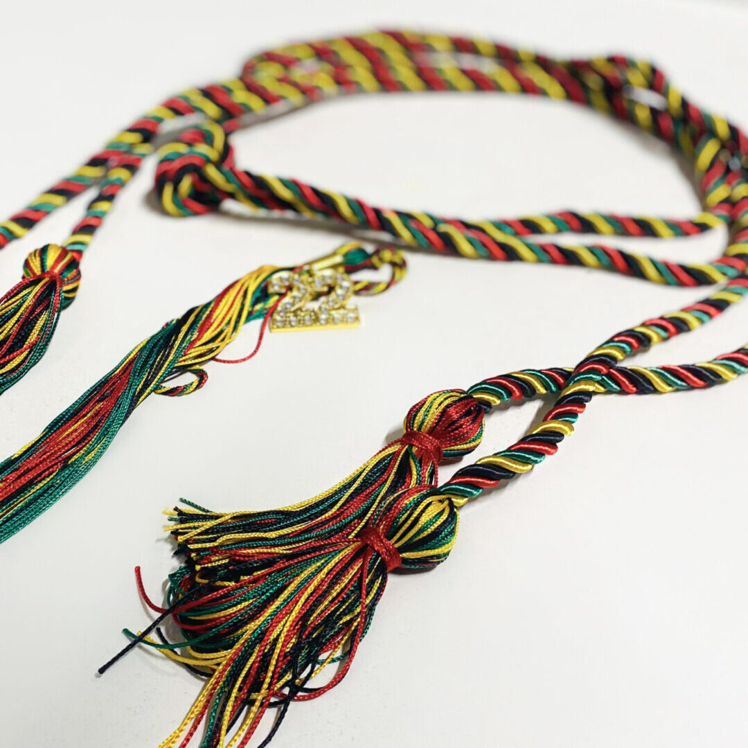 A close up of a long necklace with tassels