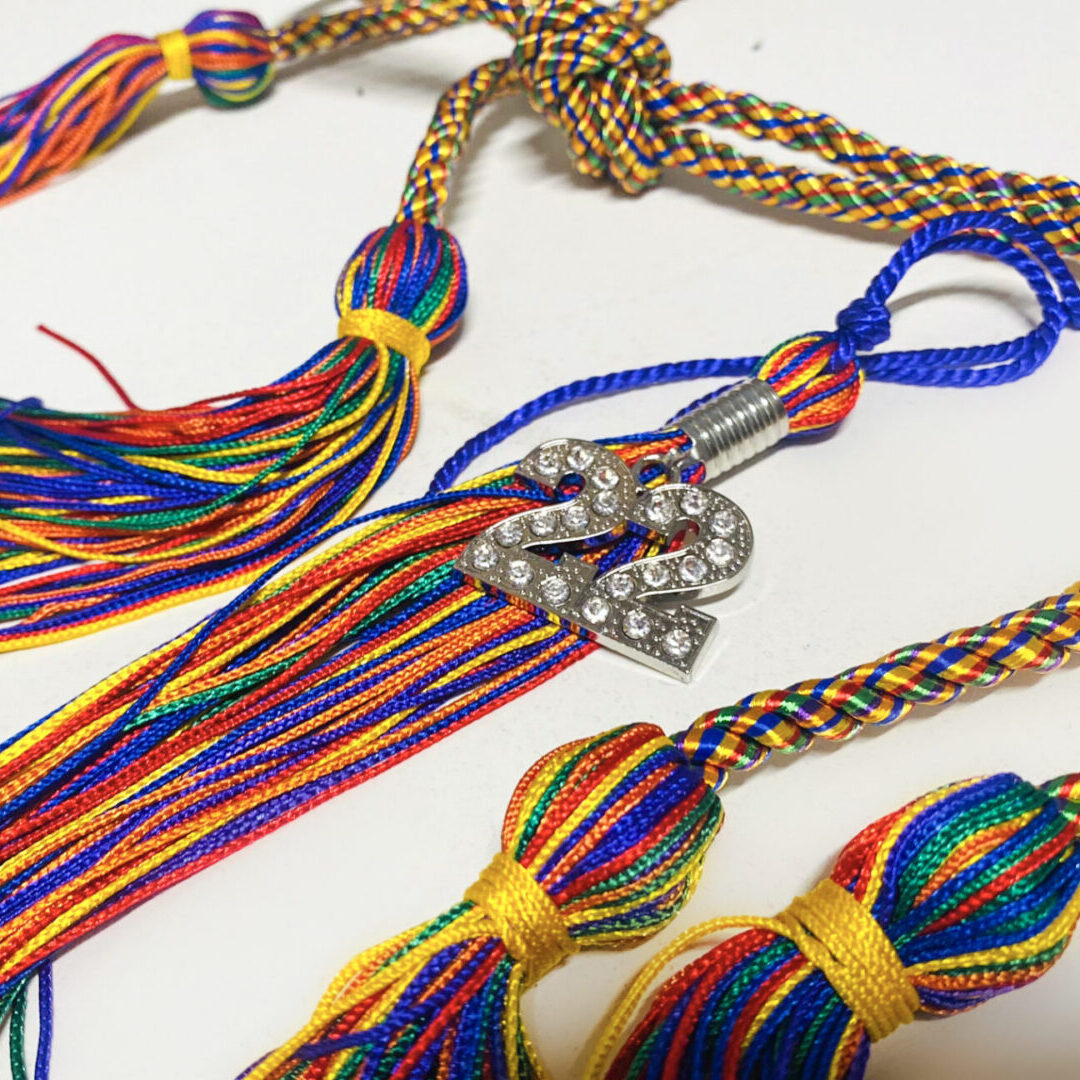 A close up of three different tassels on a table