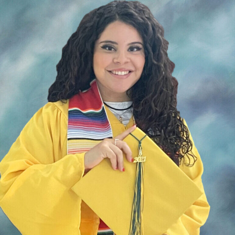 A woman in yellow jacket holding a kite.